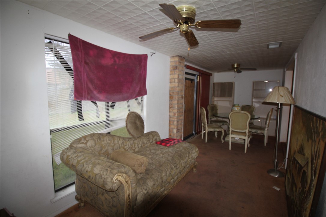 5409 Timbergate Drive Corpus Christi, TX 78413 - Photo 13 of 14 a living room with furniture a rug and a chandelier