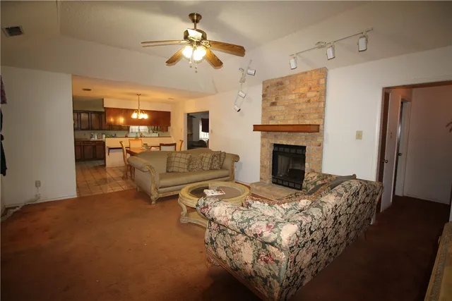 a living room with furniture fireplace and flat screen tv