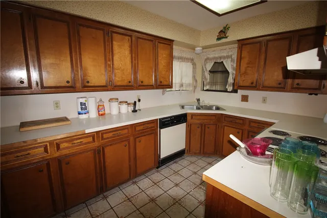 a kitchen with a sink cabinets and window