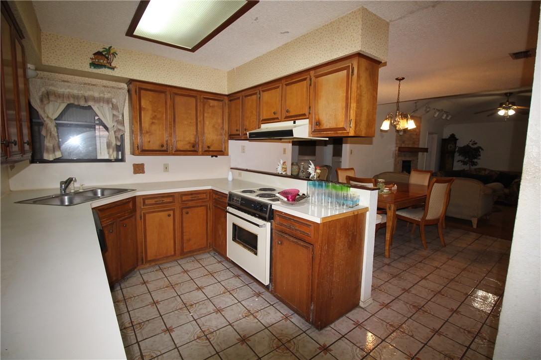 5409 Timbergate Drive Corpus Christi, TX 78413 - Photo 7 of 14 a kitchen with stainless steel appliances granite countertop a stove a sink and a microwave