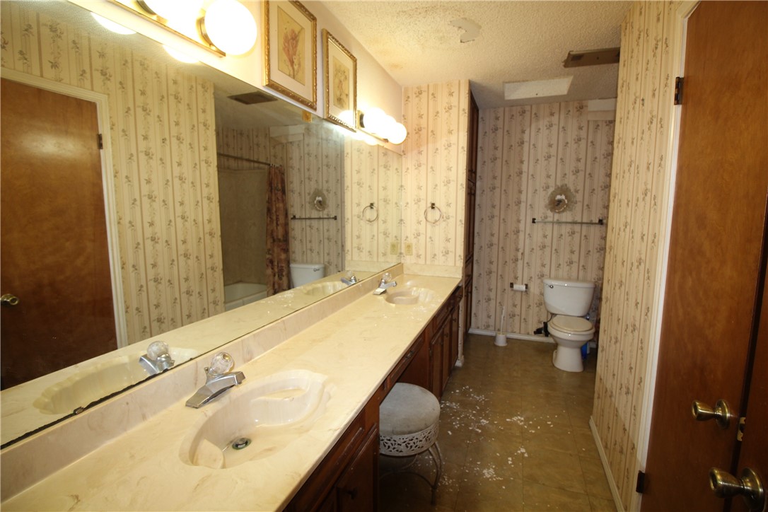 5409 Timbergate Drive Corpus Christi, TX 78413 - Photo 9 of 14 a bathroom with a sink and a large mirror