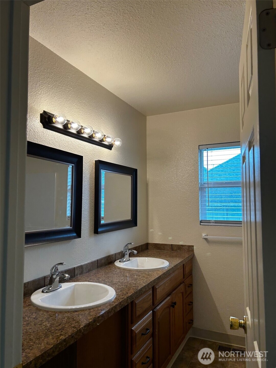 302 Crawford Street Kelso, WA 98626 - Photo 11 of 16 a bathroom with a double vanity sink and a mirror