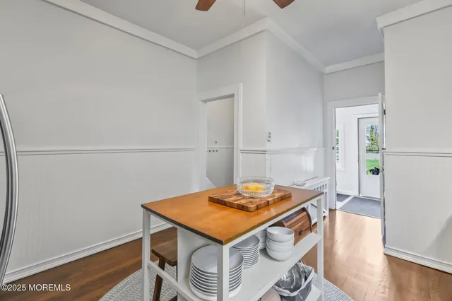a living room with dining table and wooden floor