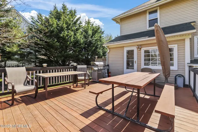 a view of a roof deck with wooden floor and furniture