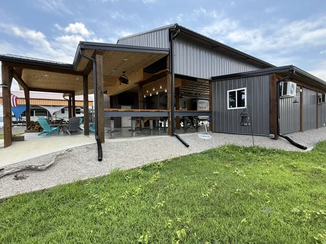 a view of a house with a small yard and wooden floor and fence