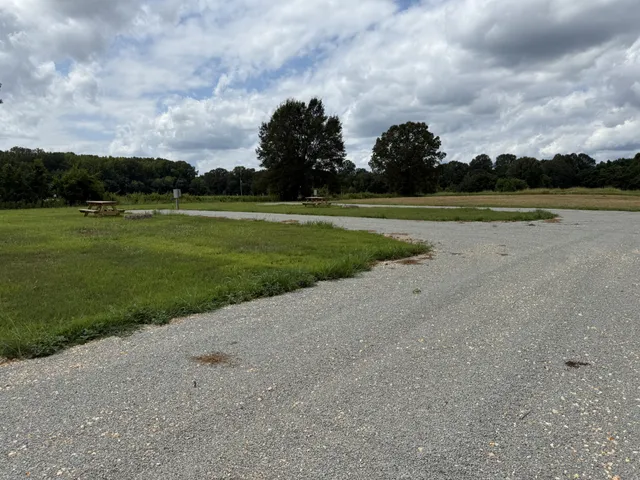 a backyard of a house with a yard and outdoor seating