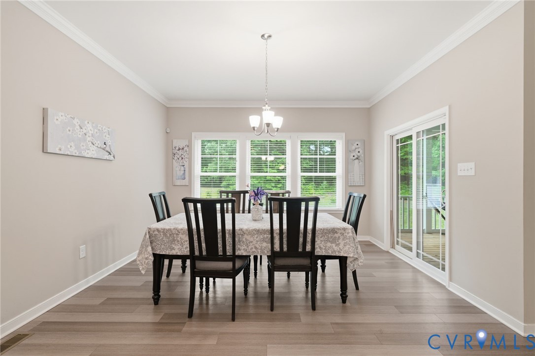7598 Rural Point Road Mechanicsville, VA 23116 - Photo 12 of 41 a view of a dining room with furniture window and wooden floor