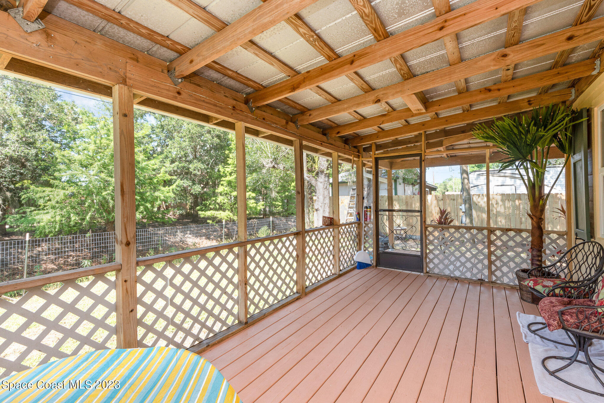 8219 Baxter Point Road Mims, FL 32754 - Photo 11 of 24 a view of a porch with wooden floor