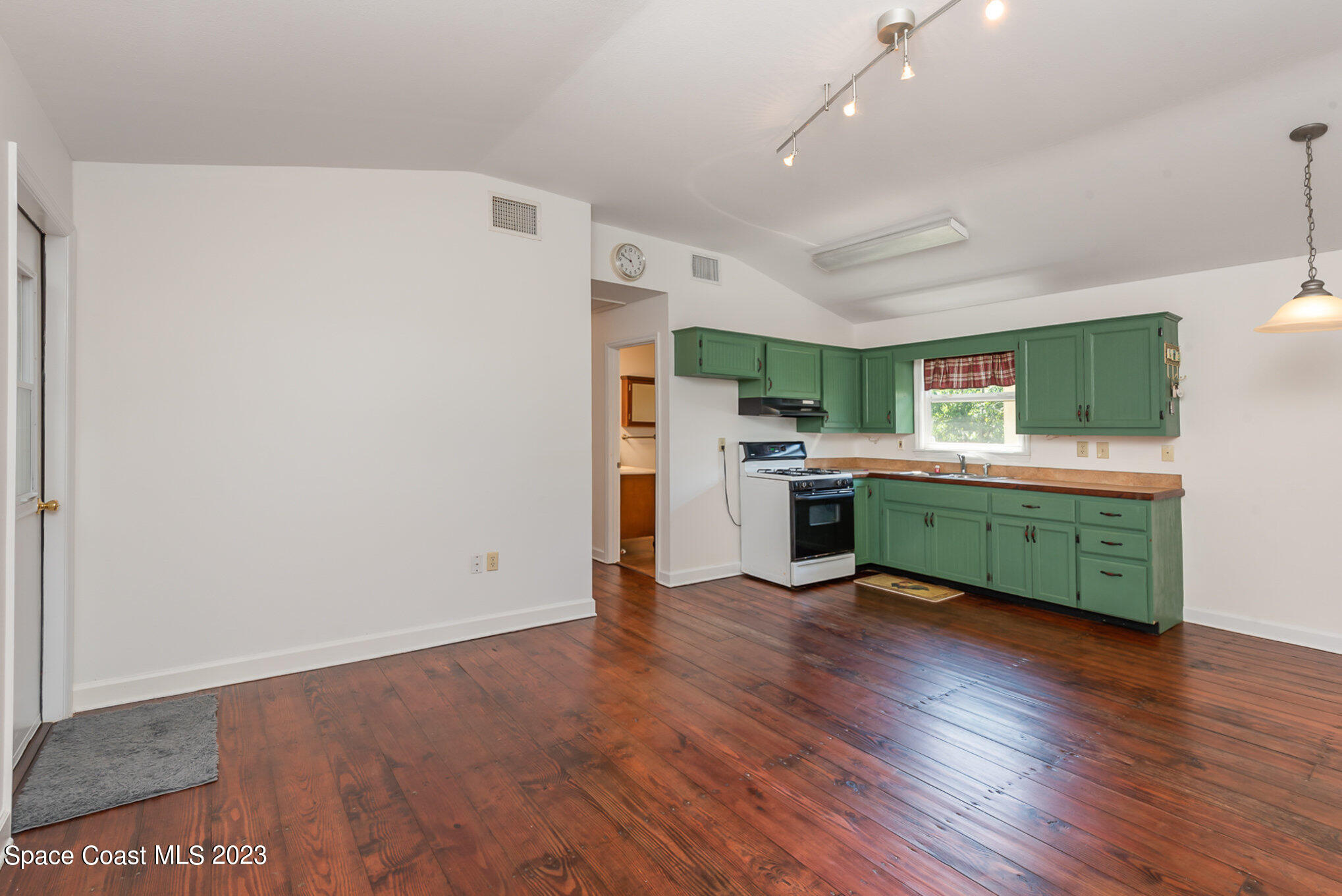 8219 Baxter Point Road Mims, FL 32754 - Photo 12 of 24 a room with stainless steel appliances granite countertop a refrigerator a sink dishwasher a stove with wooden floor