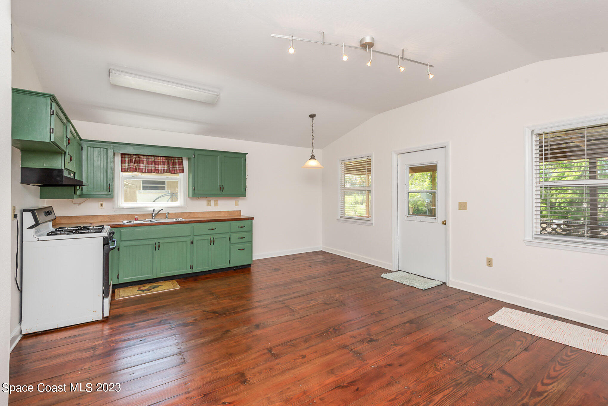8219 Baxter Point Road Mims, FL 32754 - Photo 13 of 24 a room with a wooden floor and windows