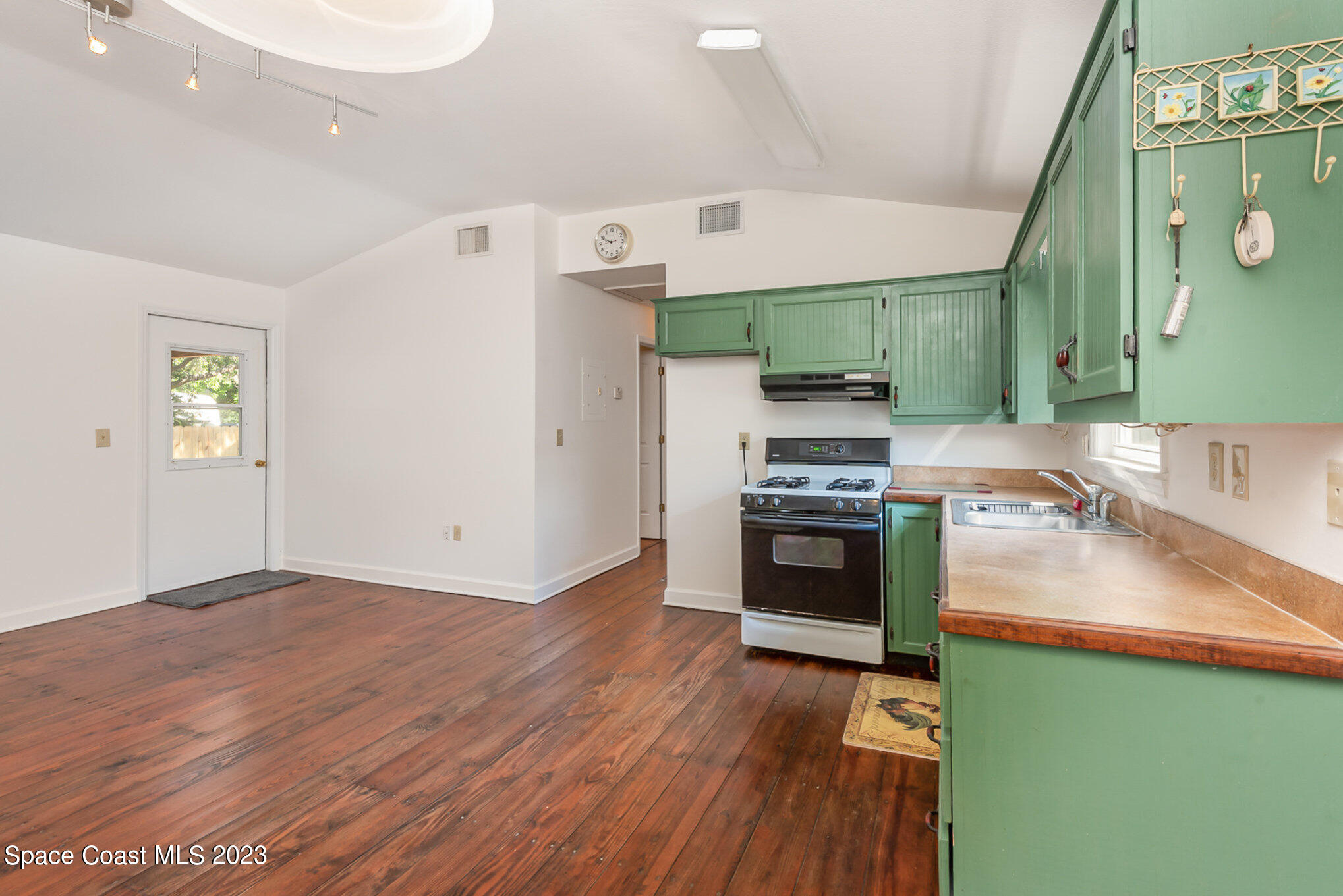 8219 Baxter Point Road Mims, FL 32754 - Photo 14 of 24 a kitchen with a refrigerator and a stove top oven
