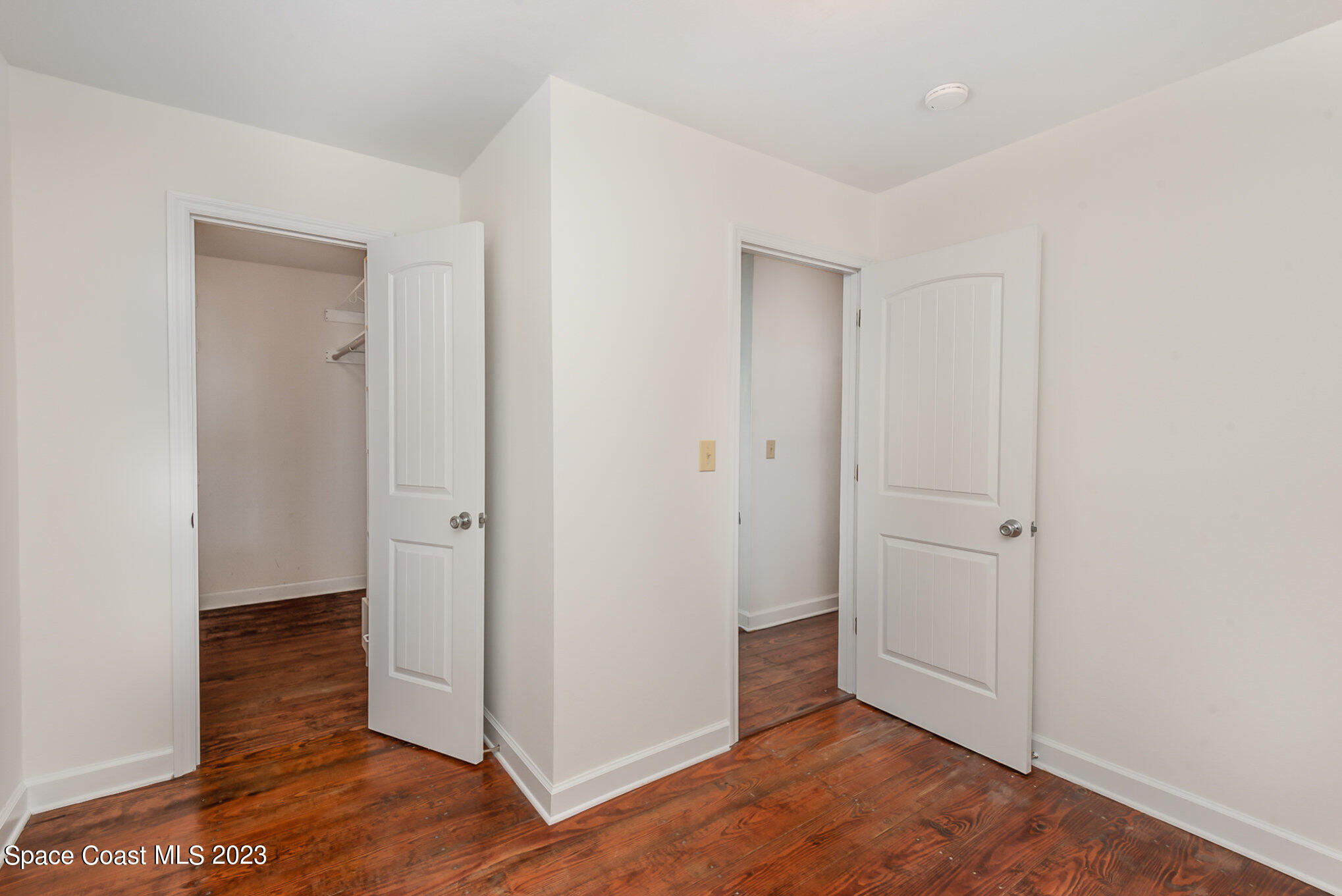 8219 Baxter Point Road Mims, FL 32754 - Photo 19 of 24 an empty room with wooden floor and closet
