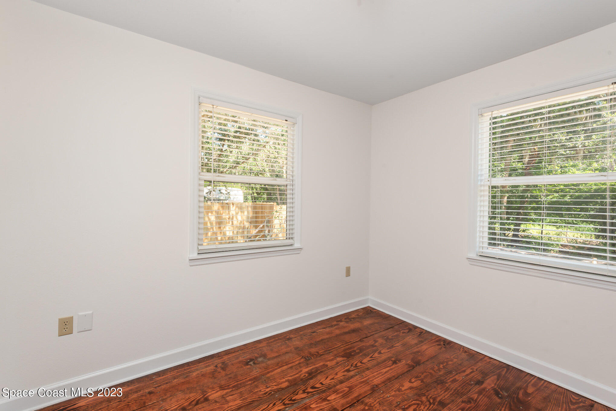 8219 Baxter Point Road Mims, FL 32754 - Photo 20 of 24 a view of an empty room with wooden floor and a window