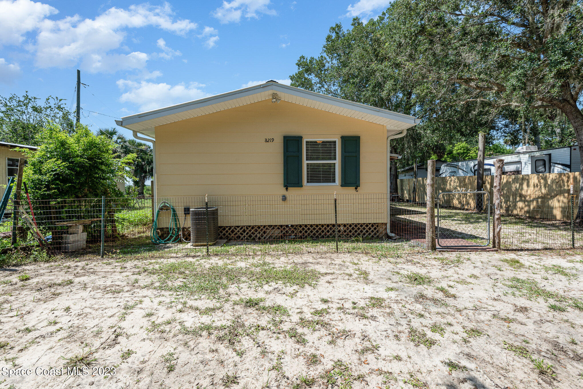 8219 Baxter Point Road Mims, FL 32754 - Photo 5 of 24 a house with trees in front of it