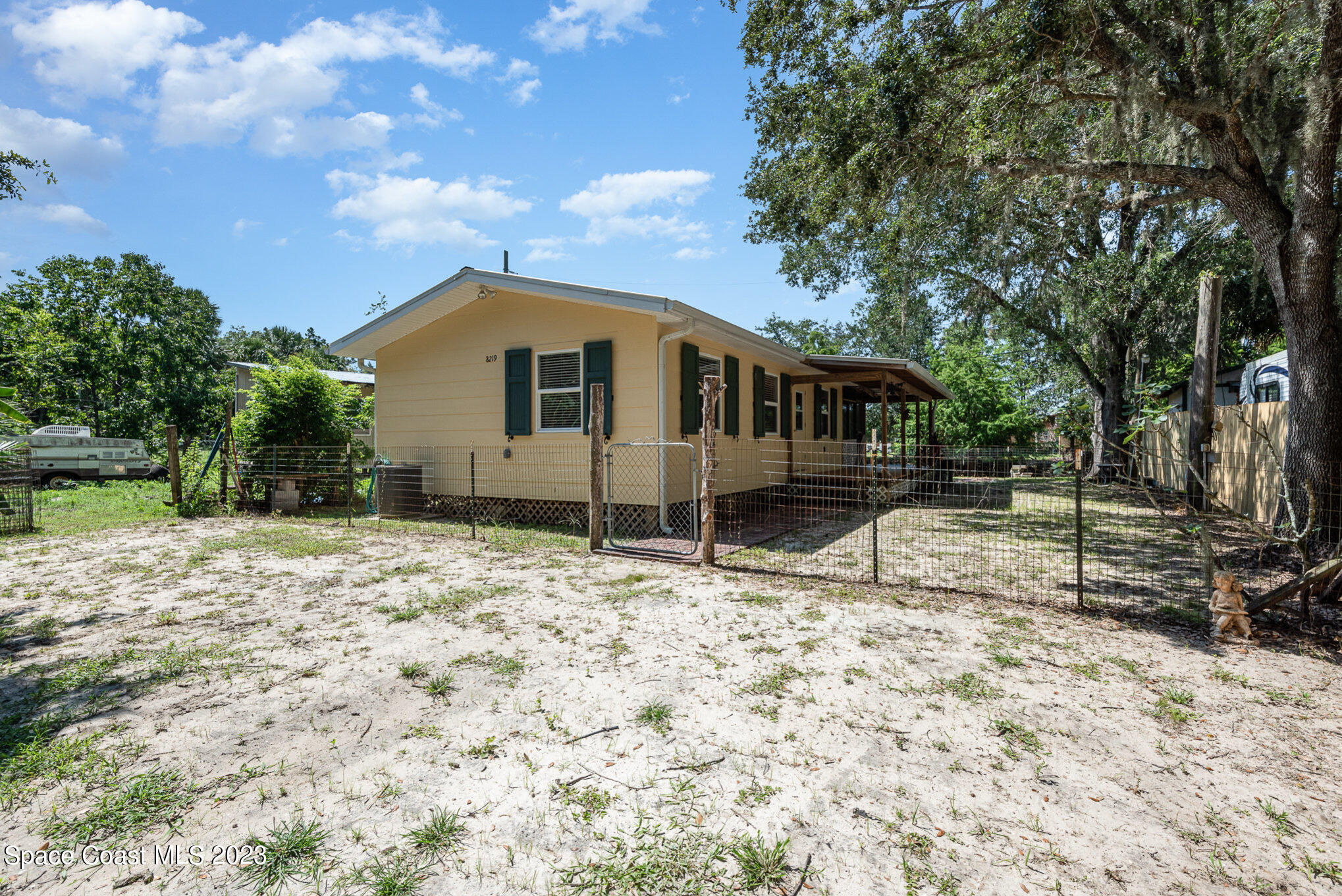 8219 Baxter Point Road Mims, FL 32754 - Photo 6 of 24 a house with trees in the background