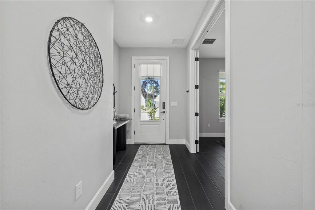 3508 Anchor Bay Trail Lakewood Ranch, FL 34211 - Photo 4 of 74 a view of a hallway with wooden floor and a hallway