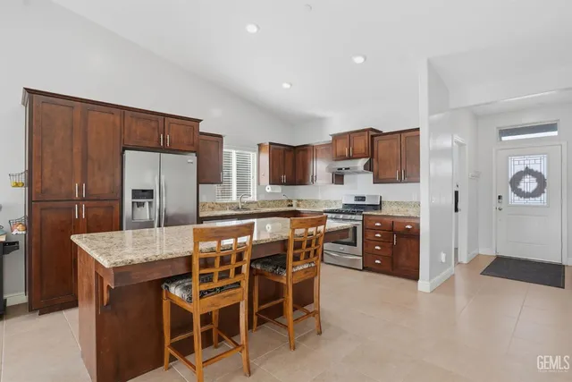a view of a dining room with furniture and a flat screen tv