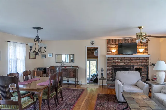a living room with furniture a fireplace and a chandelier