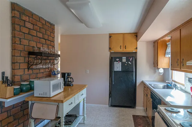 a room that has a table chair and a stove in it