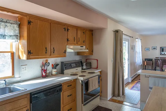 a kitchen with stainless steel appliances granite countertop a sink stove and cabinets