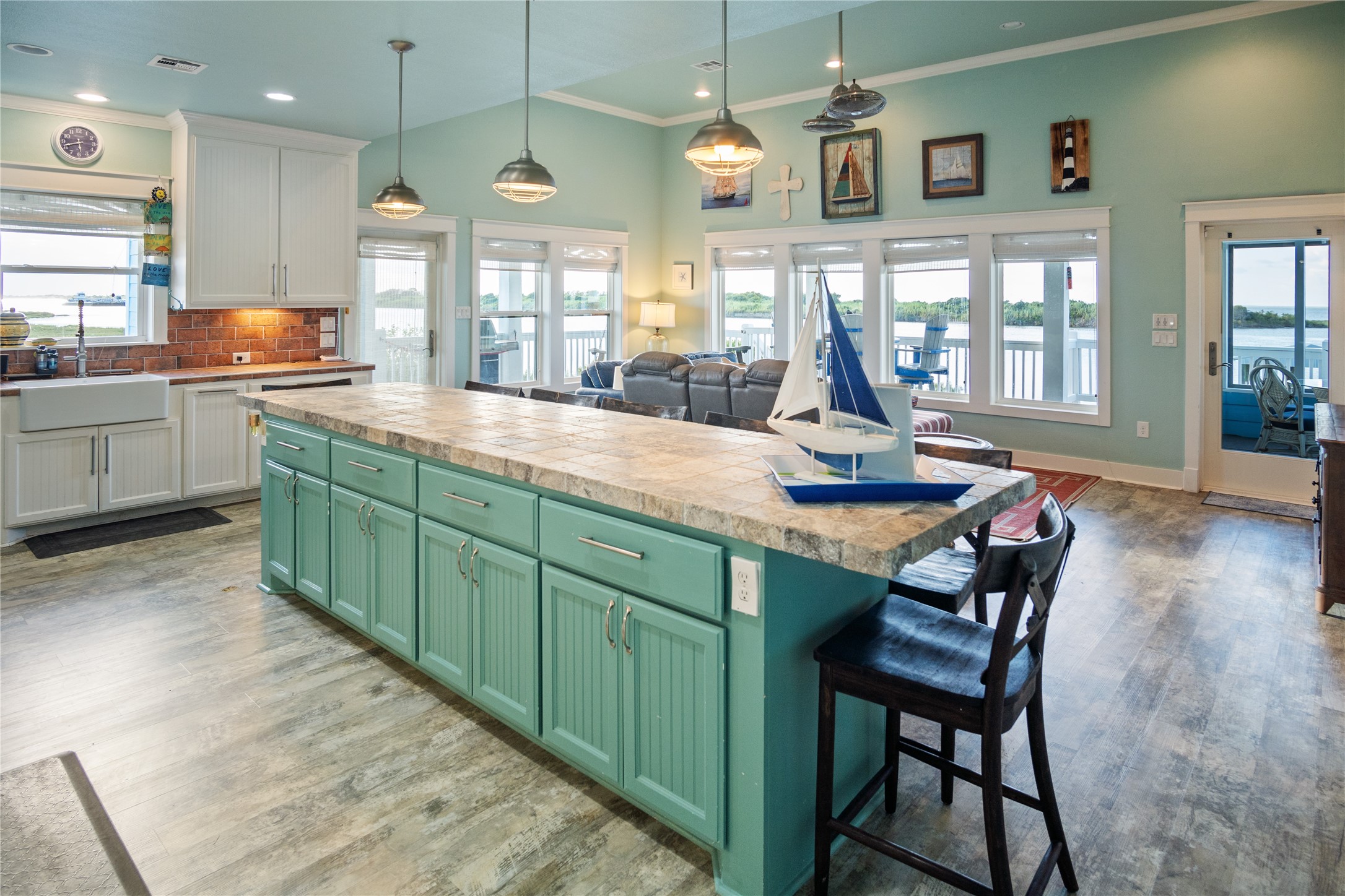 1682 Hamilton Avenue Port Bolivar, TX 77650 - Photo 11 of 38 a kitchen with granite countertop a stove a sink a dining table and chairs