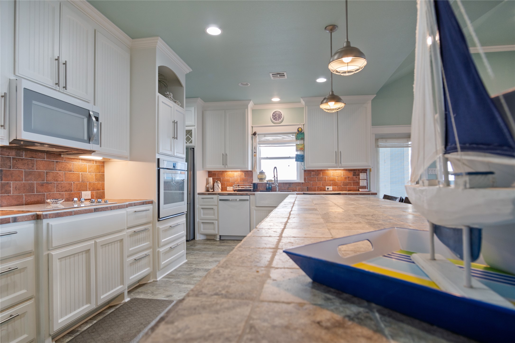 1682 Hamilton Avenue Port Bolivar, TX 77650 - Photo 14 of 38 a large kitchen with kitchen island granite countertop a sink and a stove