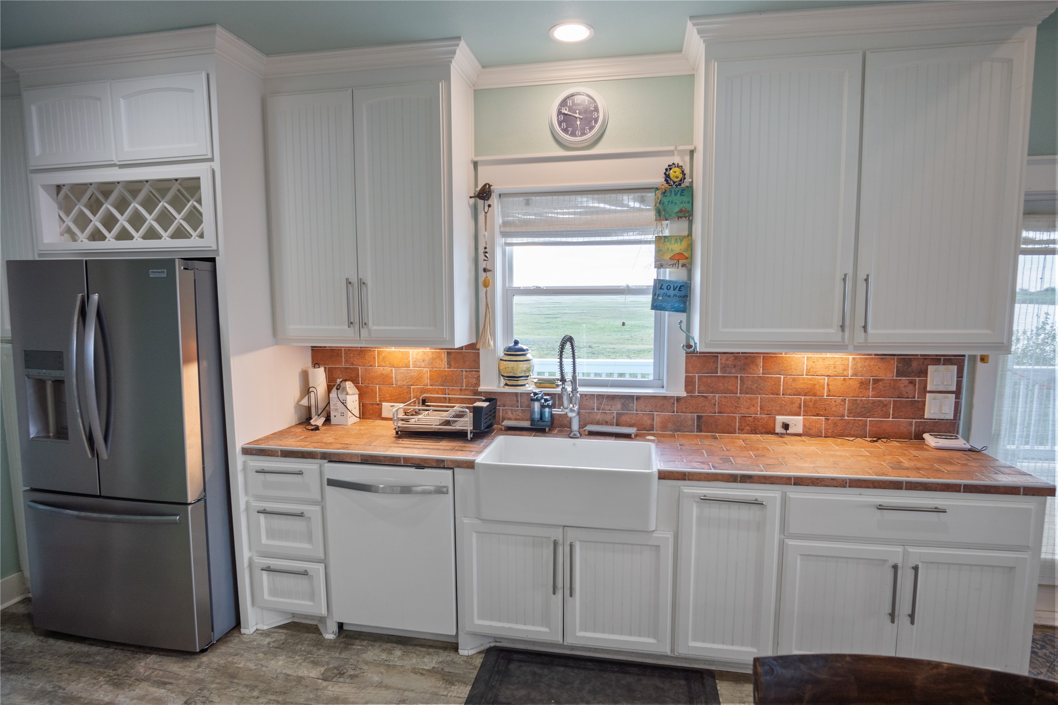 1682 Hamilton Avenue Port Bolivar, TX 77650 - Photo 15 of 38 a kitchen with white cabinets and white appliances