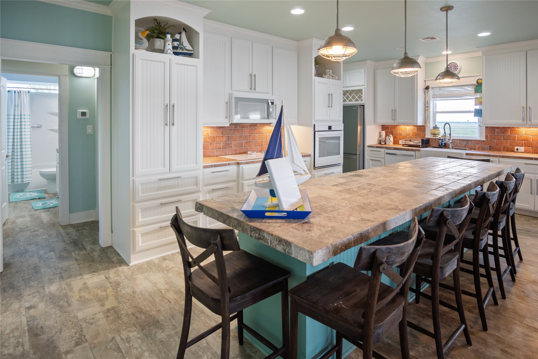 1682 Hamilton Avenue Port Bolivar, TX 77650 - Photo 17 of 38 a dining room with a table chairs and a kitchen view