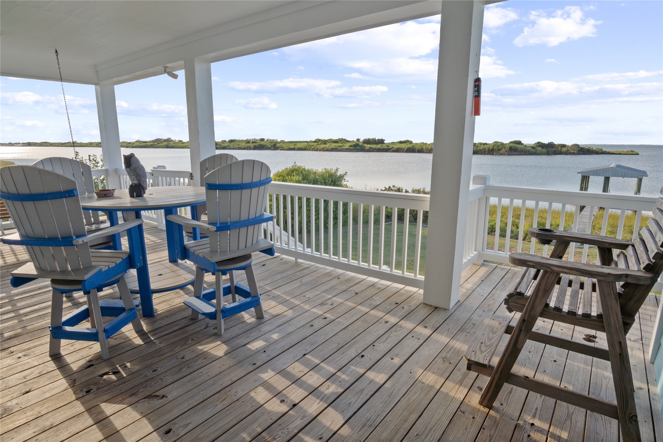 1682 Hamilton Avenue Port Bolivar, TX 77650 - Photo 3 of 38 a view of a balcony with chairs and wooden floor