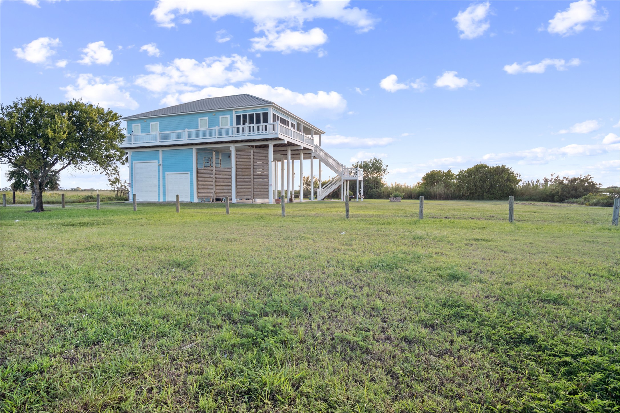 1682 Hamilton Avenue Port Bolivar, TX 77650 - Photo 33 of 38 a view of a big house with a big yard and large trees