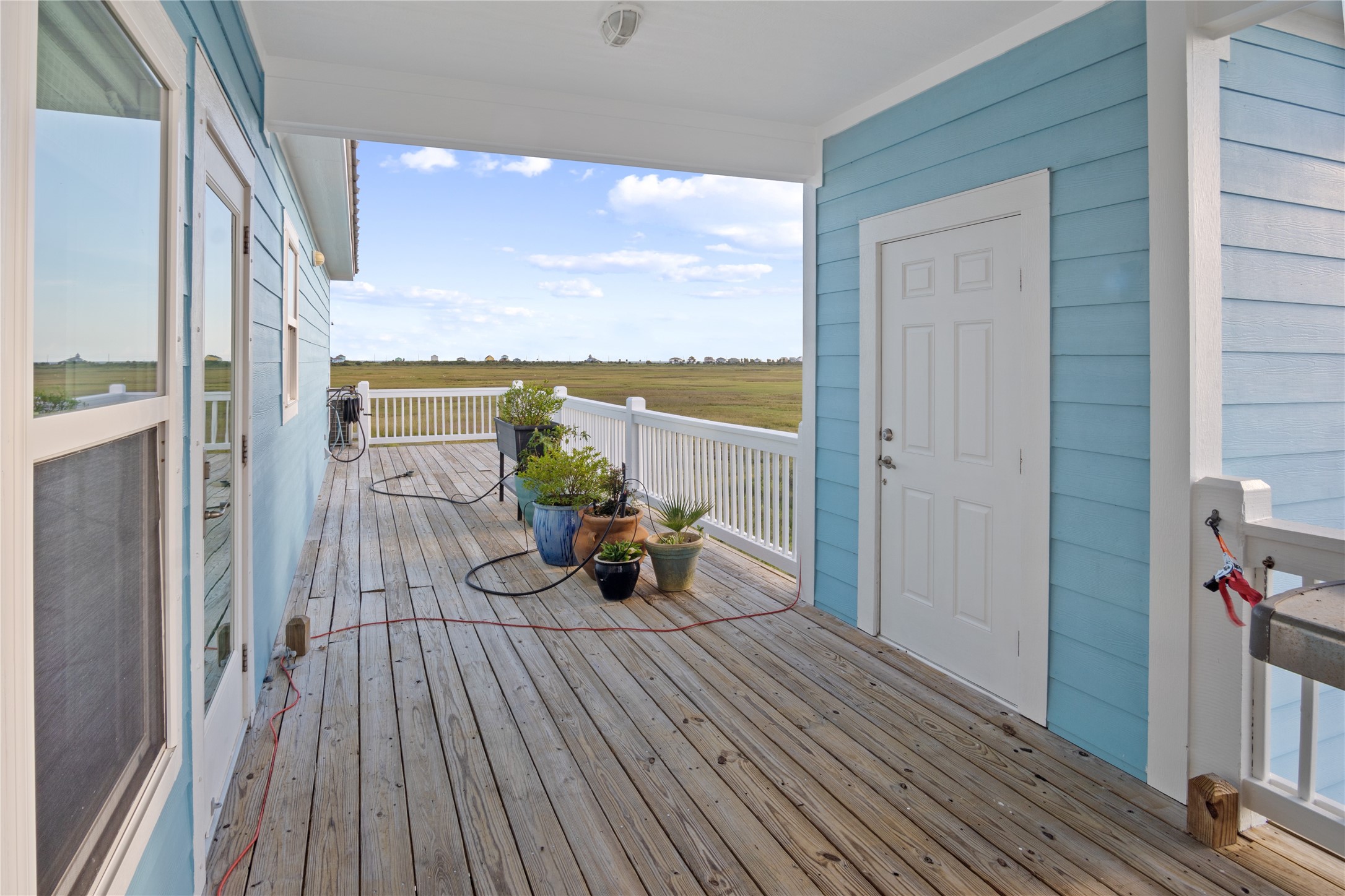 1682 Hamilton Avenue Port Bolivar, TX 77650 - Photo 34 of 38 a view of a balcony with chair and floor to ceiling window