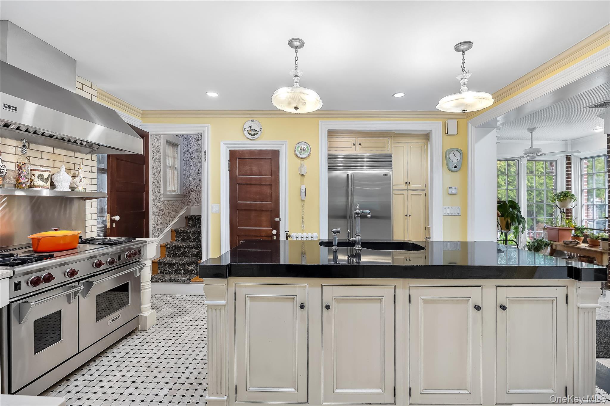 1-27 Beverly Road Queens, NY 11363 - Photo 31 of 46 a large kitchen with granite countertop a stove a sink and a chandelier