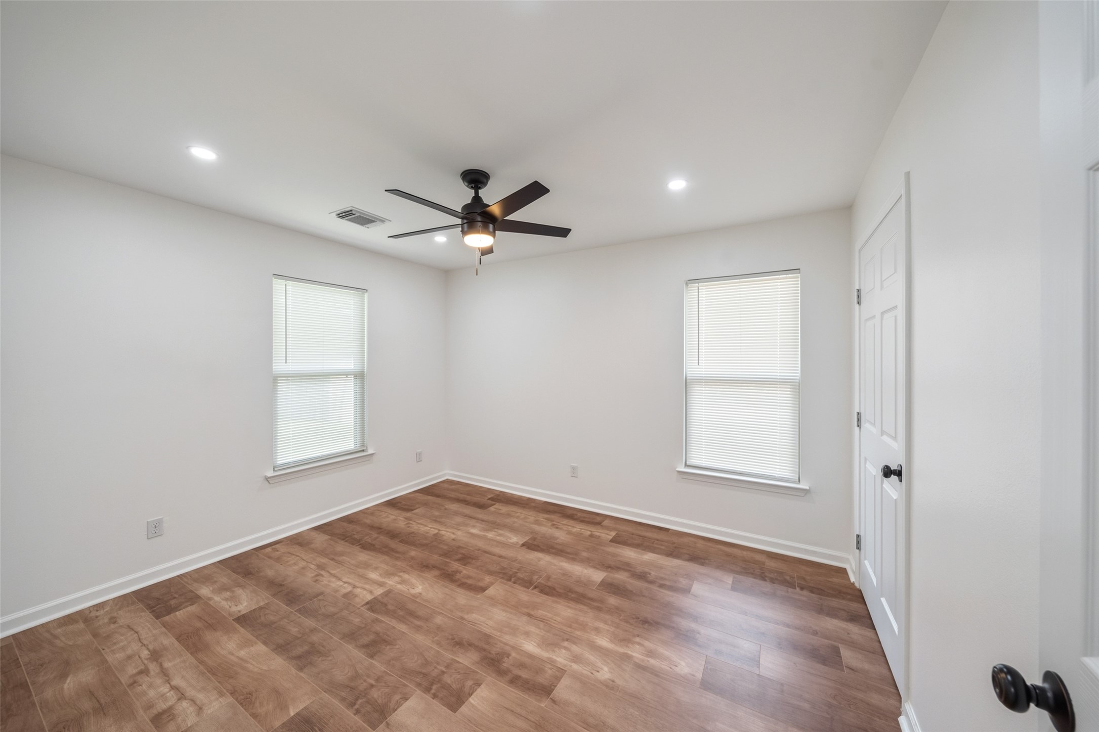 3051 Rothermel Road Houston, TX 77093 - Photo 16 of 24 Bright guest bedroom featuring a ceiling fan and elegant recessed lighting.