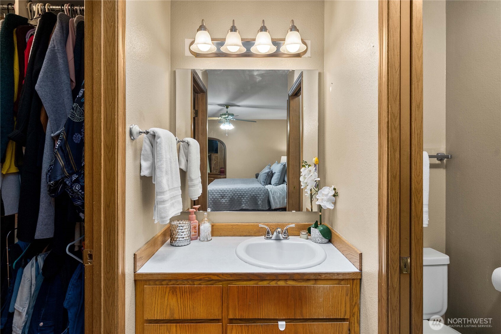 5103 South Garden Loop Road, Unit 25 Seattle, WA 98118 - Photo 11 of 23 a bathroom with a sink mirror and vanity