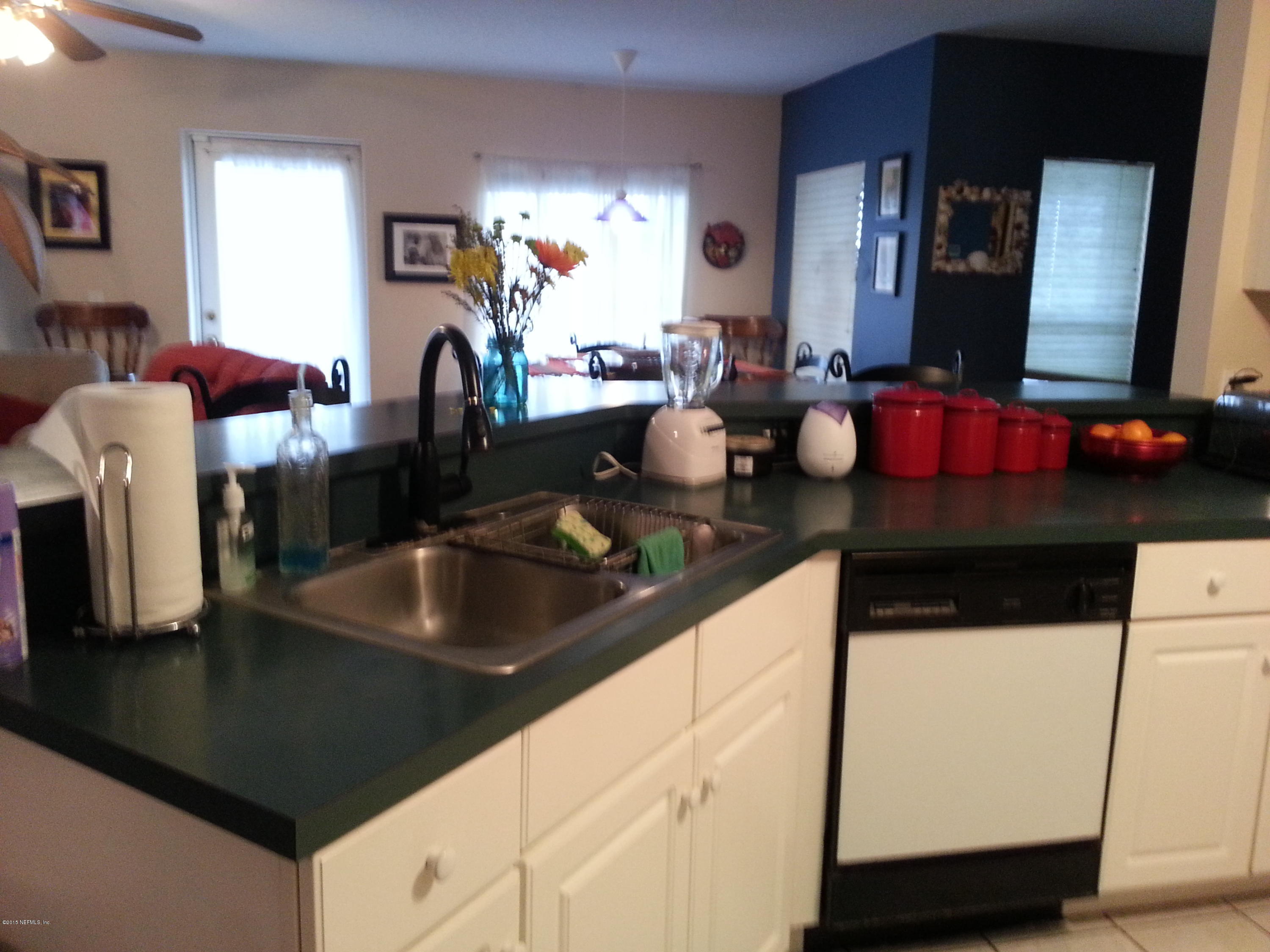 308 Outrigger Way Vilano Beach, FL 32084 - Photo 19 of 33 a kitchen with a sink and a refrigerator