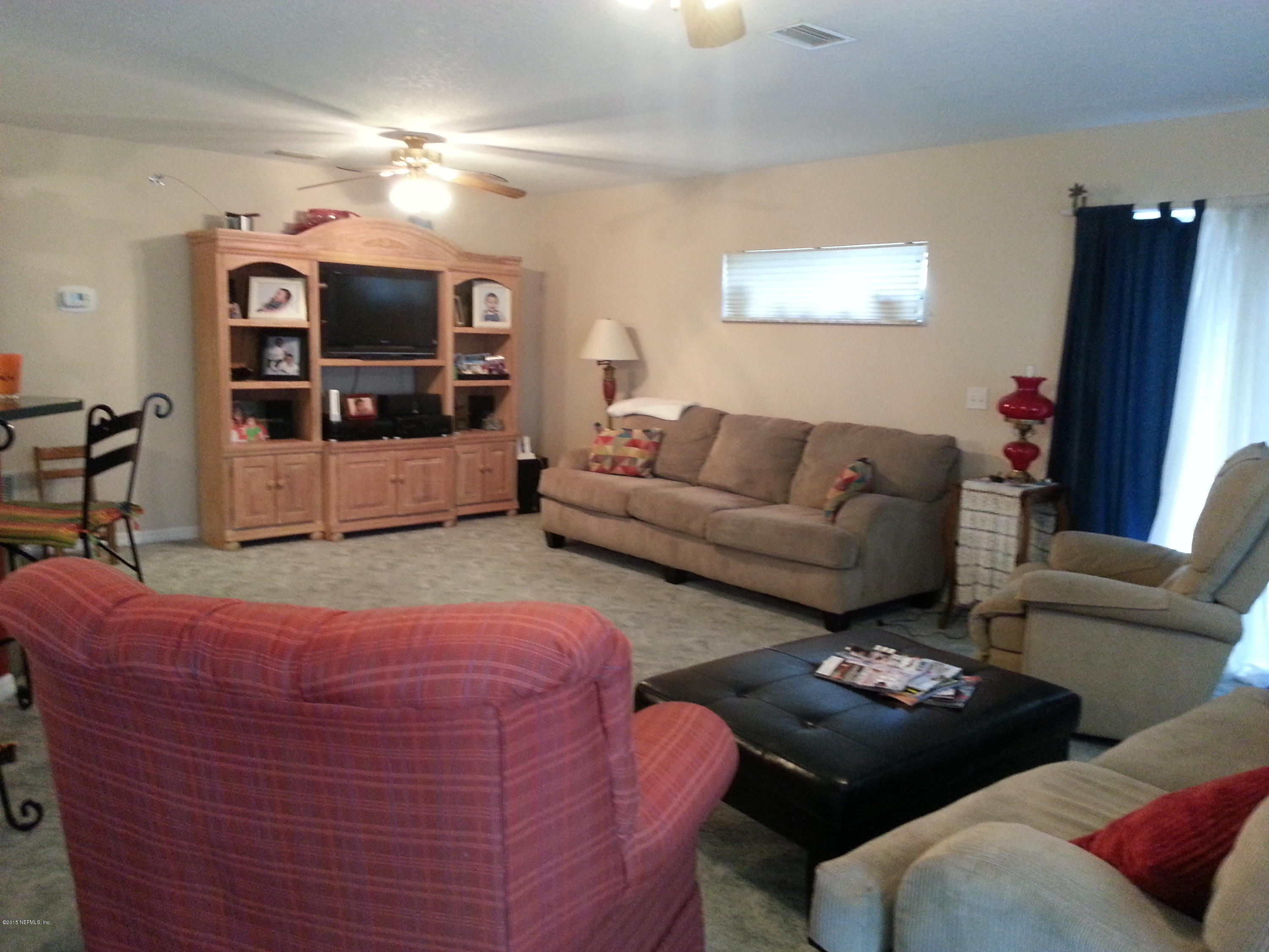 308 Outrigger Way Vilano Beach, FL 32084 - Photo 22 of 33 a living room with furniture and a flat screen tv