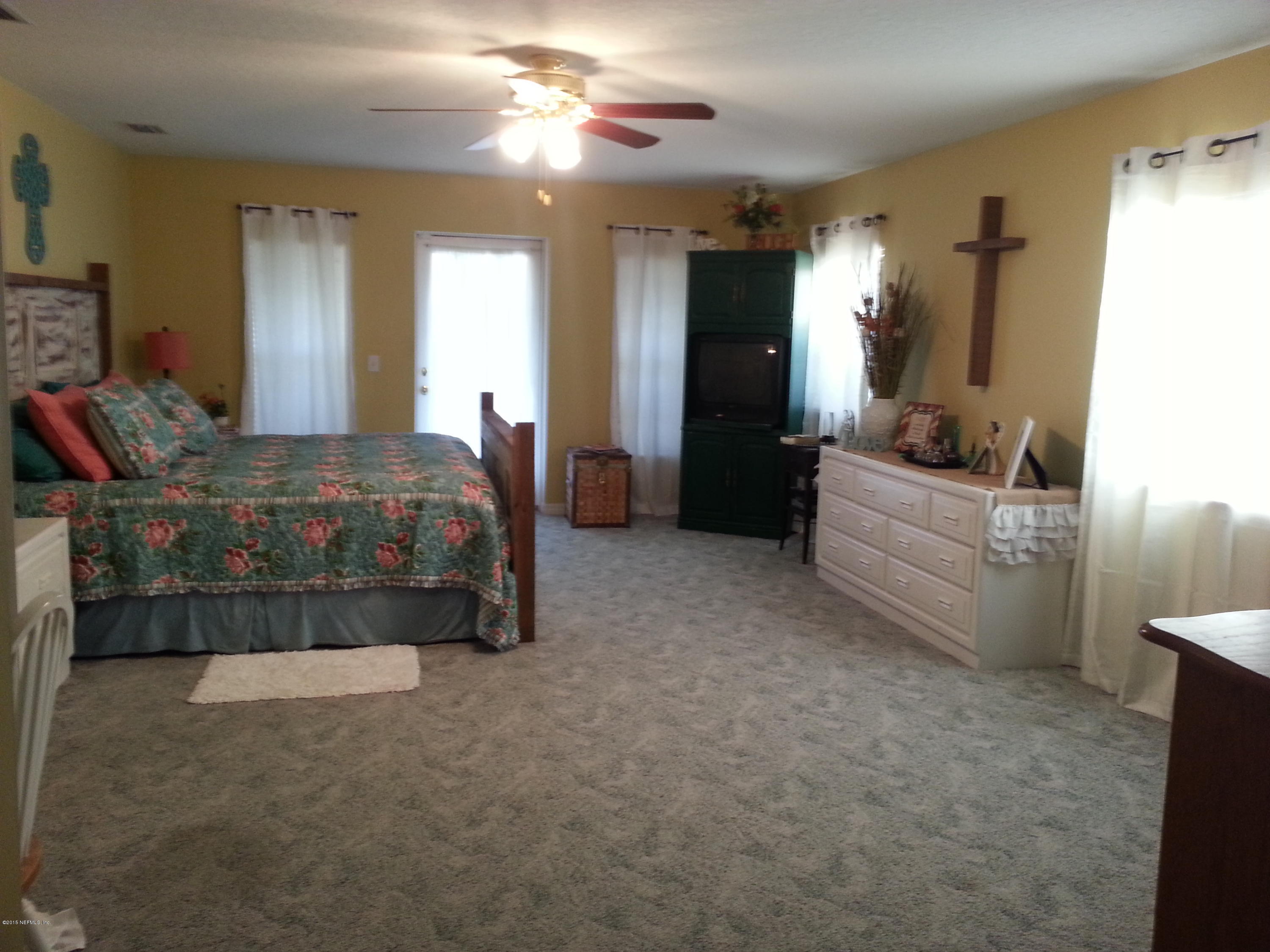 308 Outrigger Way Vilano Beach, FL 32084 - Photo 24 of 33 a living room with furniture and a chandelier