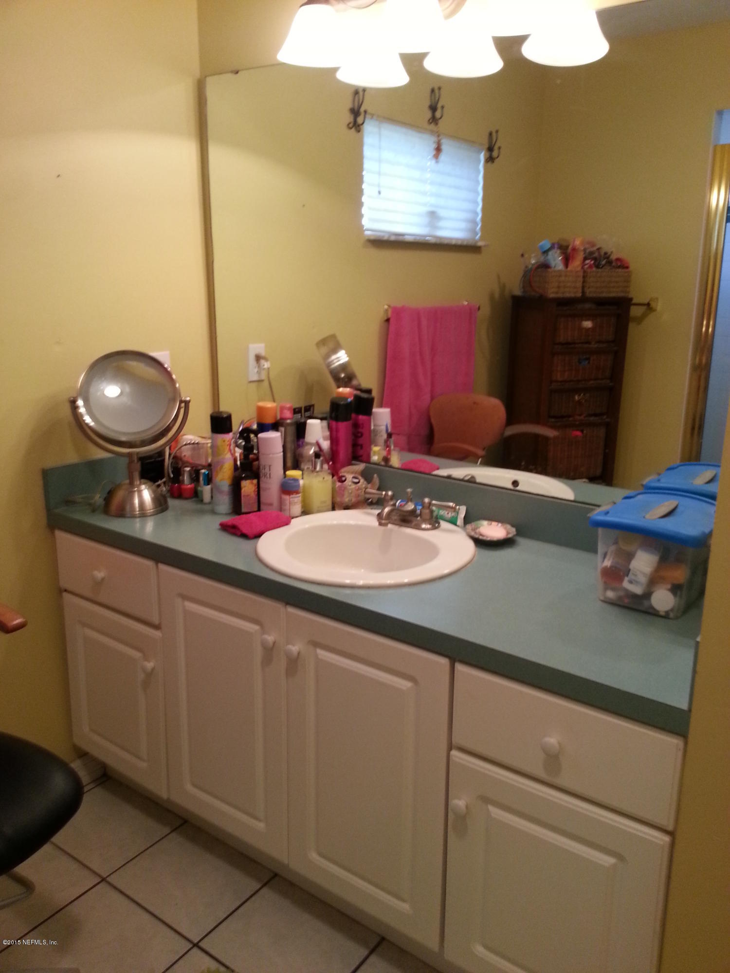 308 Outrigger Way Vilano Beach, FL 32084 - Photo 29 of 33 a bathroom with a sink and a mirror