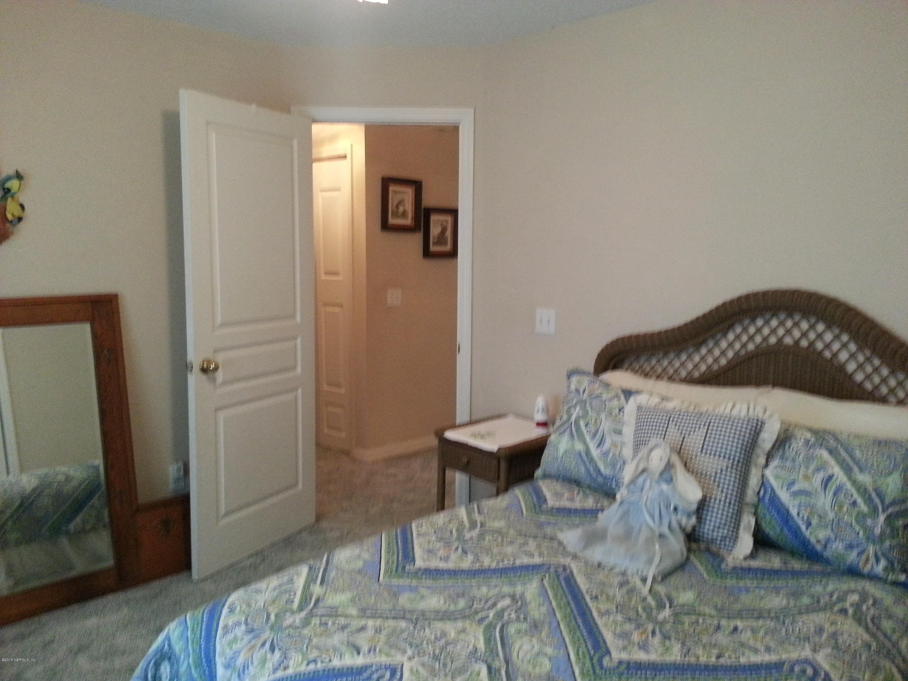 308 Outrigger Way Vilano Beach, FL 32084 - Photo 3 of 33 a bedroom with a bed and wooden floor