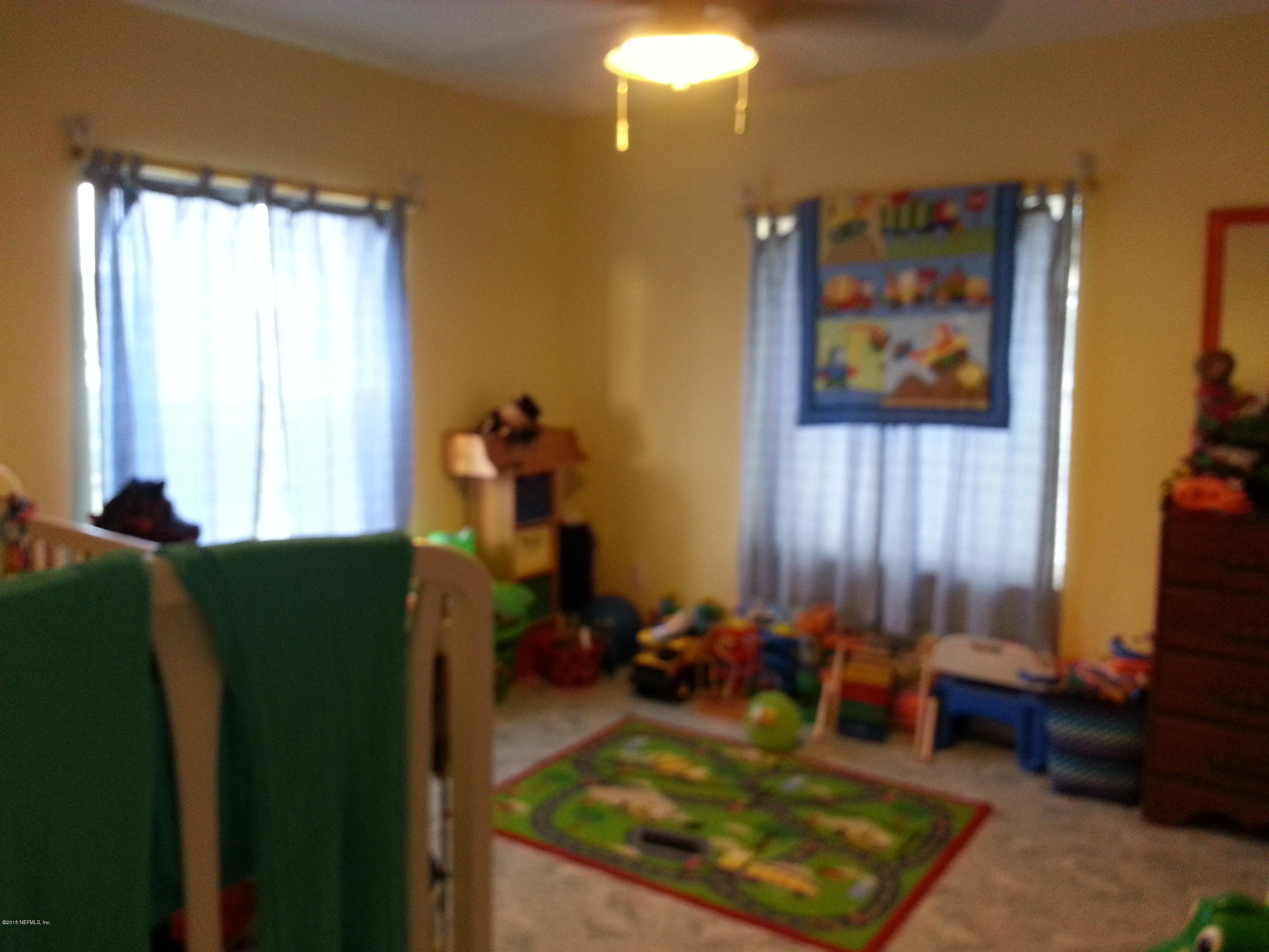 308 Outrigger Way Vilano Beach, FL 32084 - Photo 31 of 33 a living room with furniture and a window