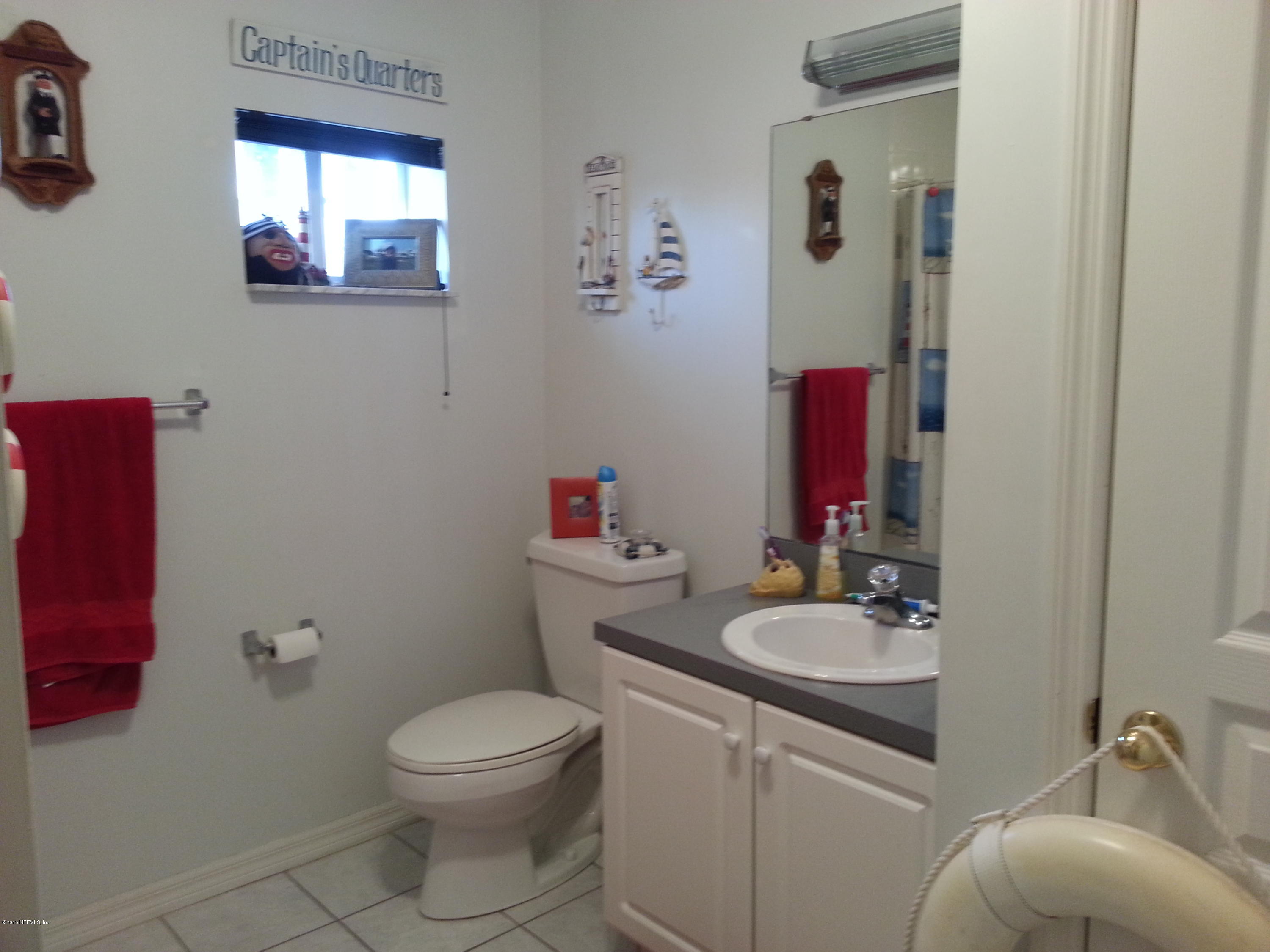 308 Outrigger Way Vilano Beach, FL 32084 - Photo 4 of 33 a bathroom with a sink toilet and mirror