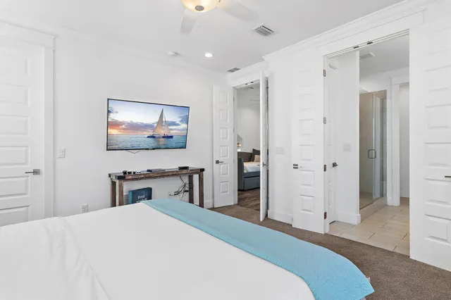 a bedroom with a bed and a flat screen tv