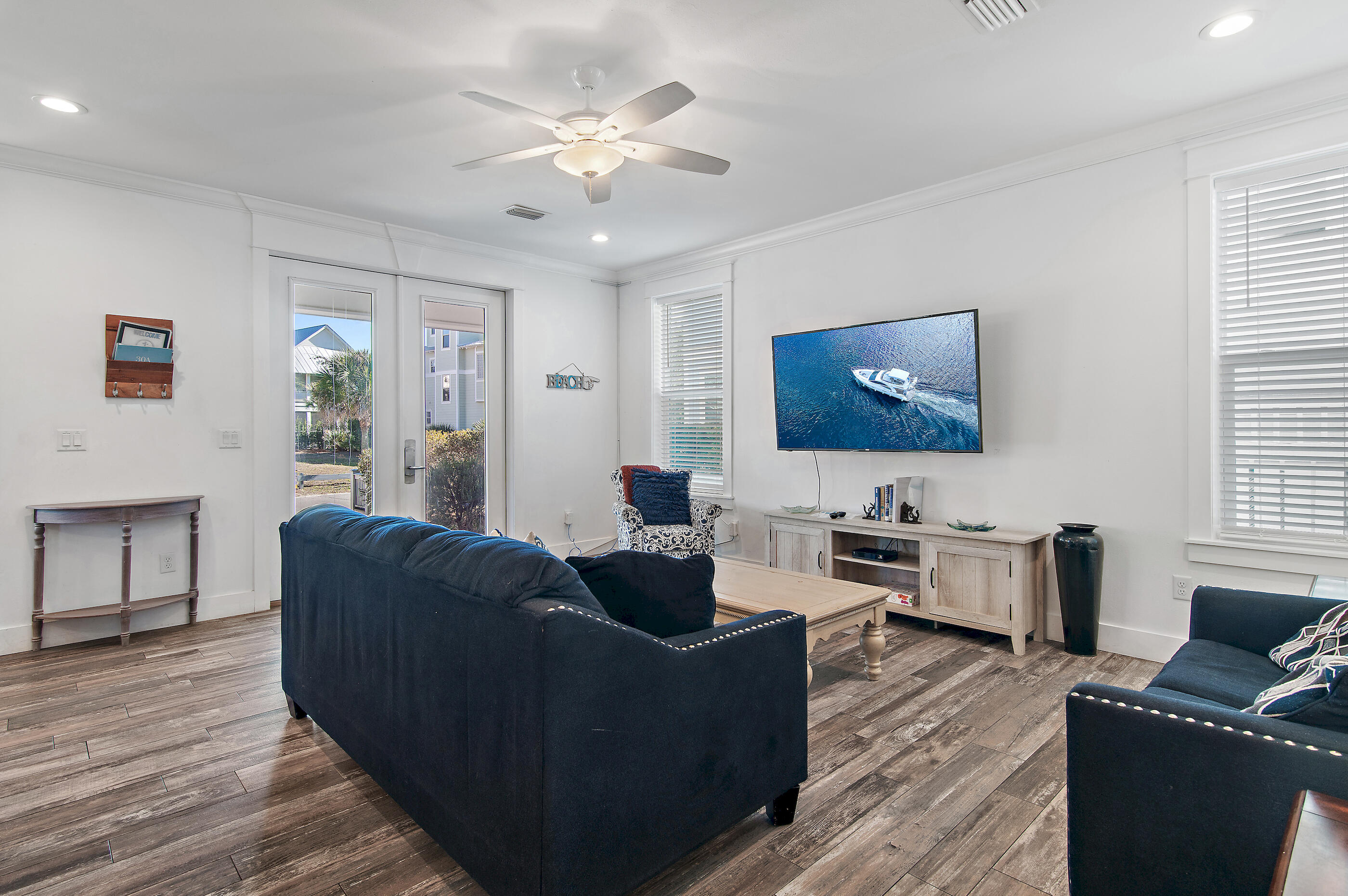 33 Sugar Sand Lane Santa Rosa Beach, FL 32459 - Photo 4 of 35 a living room with furniture a flat screen tv and wooden floor