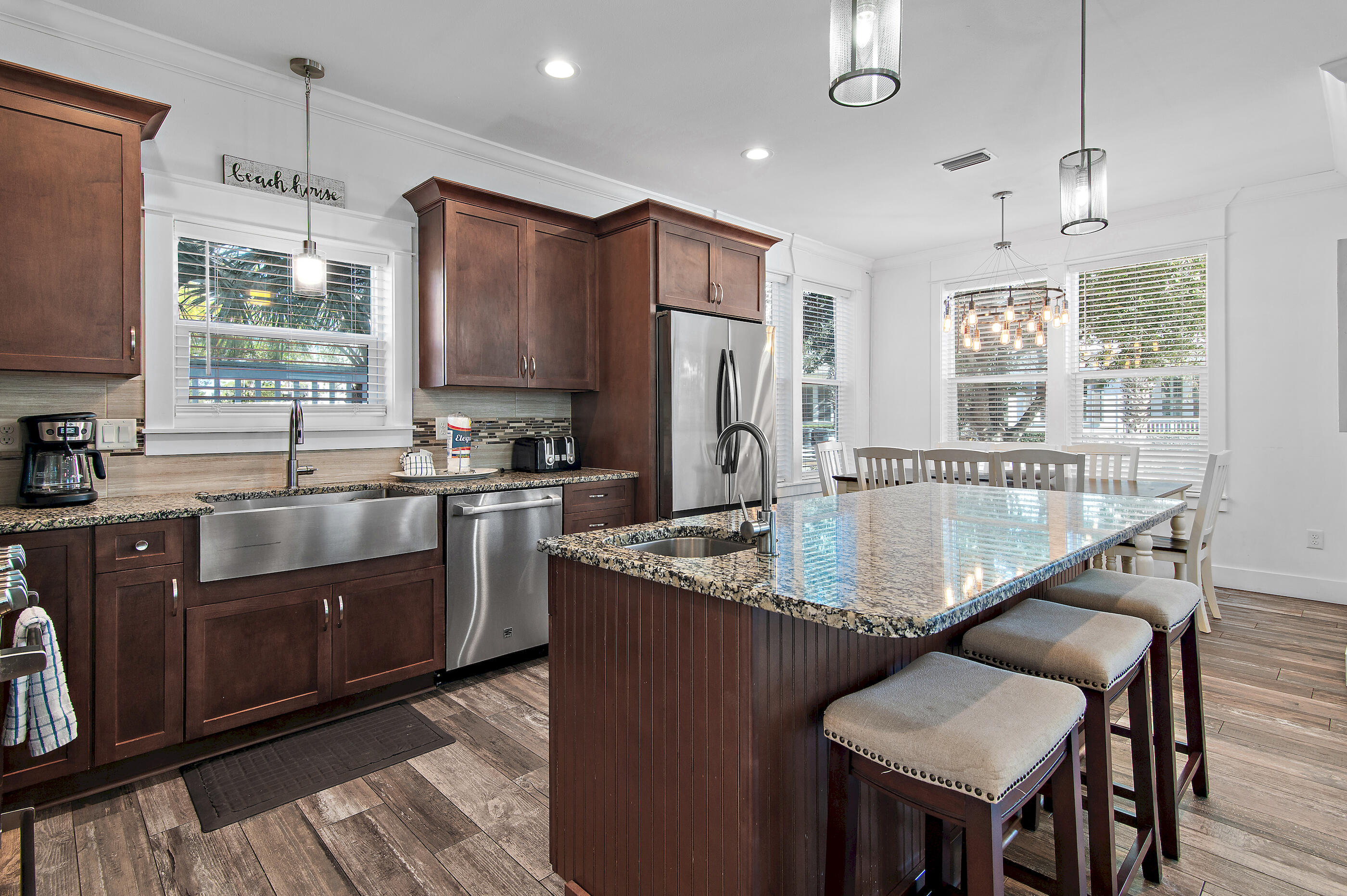 33 Sugar Sand Lane Santa Rosa Beach, FL 32459 - Photo 5 of 35 a kitchen with stainless steel appliances granite countertop a sink a stove a refrigerator a center island and a window