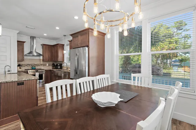 a kitchen with a table chairs refrigerator and chairs