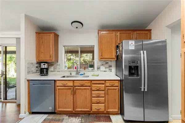 a kitchen with stainless steel appliances a refrigerator sink and cabinets