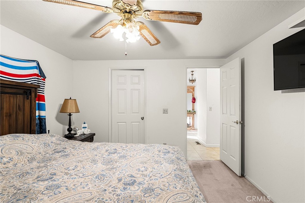 2050 Springfield Drive, Unit 323 Chico, CA 95928 - Photo 25 of 43 a bedroom with a bed and a flat screen tv