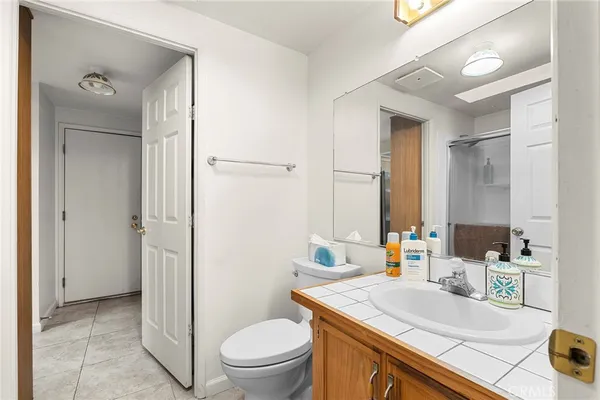a bathroom with a sink toilet vanity and shower