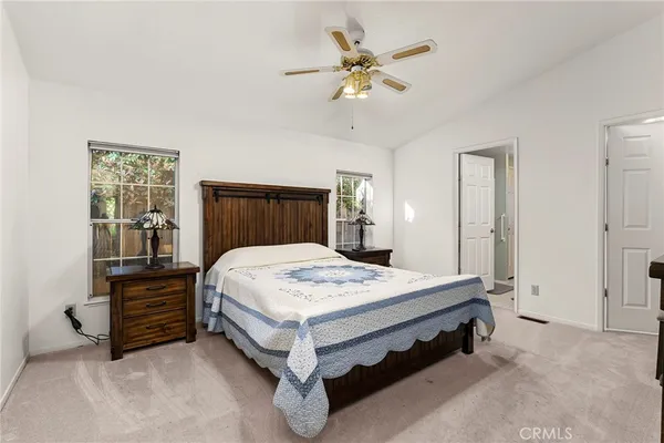 a bed sitting in a spacious bedroom