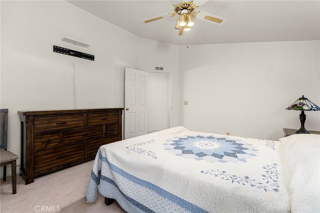 2050 Springfield Drive, Unit 323 Chico, CA 95928 - Photo 29 of 43 a bedroom with a bed and a chandelier